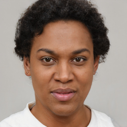 Joyful black young-adult female with short  brown hair and brown eyes