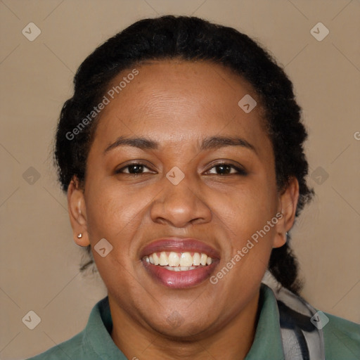 Joyful black adult female with short  brown hair and brown eyes