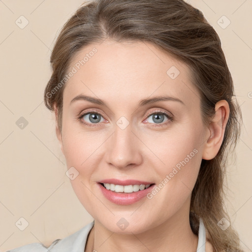 Joyful white young-adult female with medium  brown hair and blue eyes