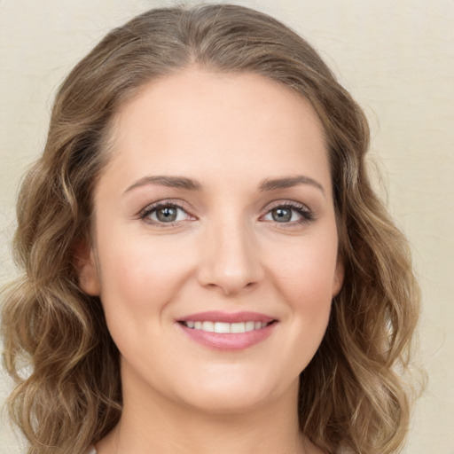 Joyful white young-adult female with long  brown hair and green eyes