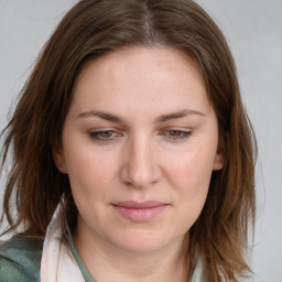 Joyful white young-adult female with medium  brown hair and green eyes