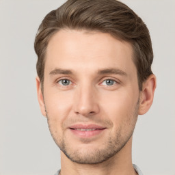 Joyful white young-adult male with short  brown hair and grey eyes