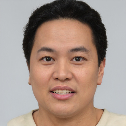Joyful asian young-adult male with short  brown hair and brown eyes