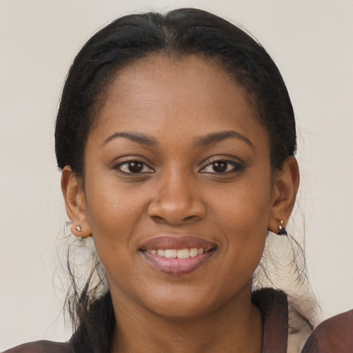 Joyful black young-adult female with medium  brown hair and brown eyes