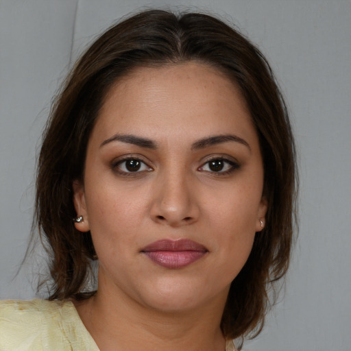 Joyful white young-adult female with medium  brown hair and brown eyes