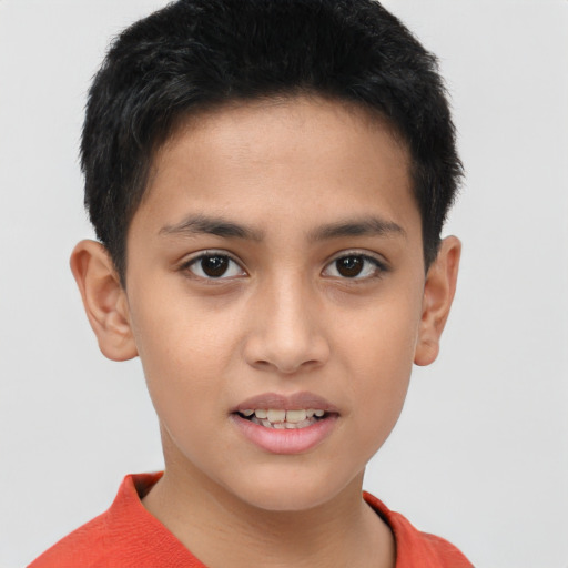 Joyful asian child male with short  brown hair and brown eyes