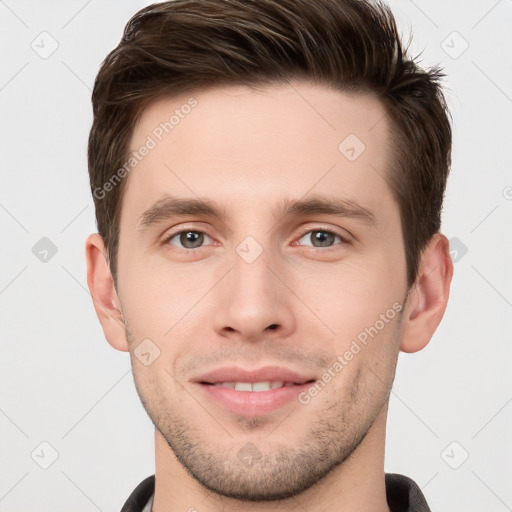 Joyful white young-adult male with short  brown hair and grey eyes