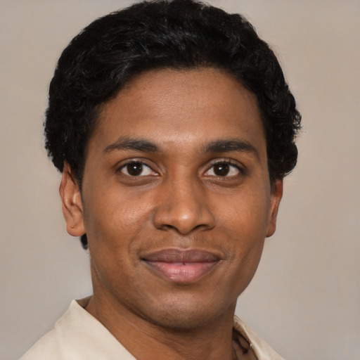 Joyful latino young-adult male with short  brown hair and brown eyes