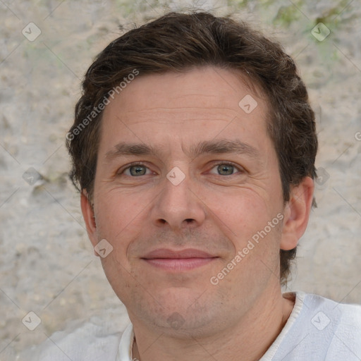 Joyful white adult male with short  brown hair and grey eyes