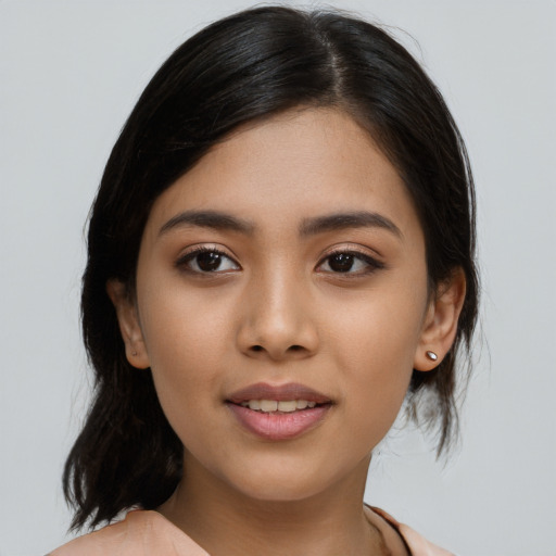 Joyful asian young-adult female with medium  brown hair and brown eyes