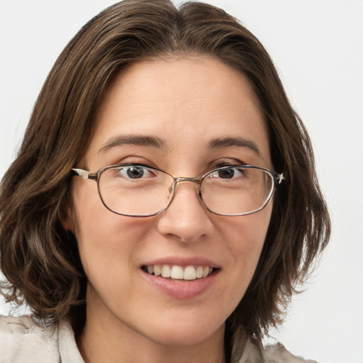 Joyful white young-adult female with medium  brown hair and green eyes