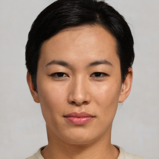 Joyful asian young-adult female with short  black hair and brown eyes