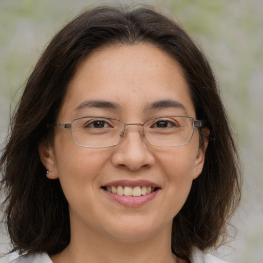 Joyful white adult female with medium  brown hair and brown eyes