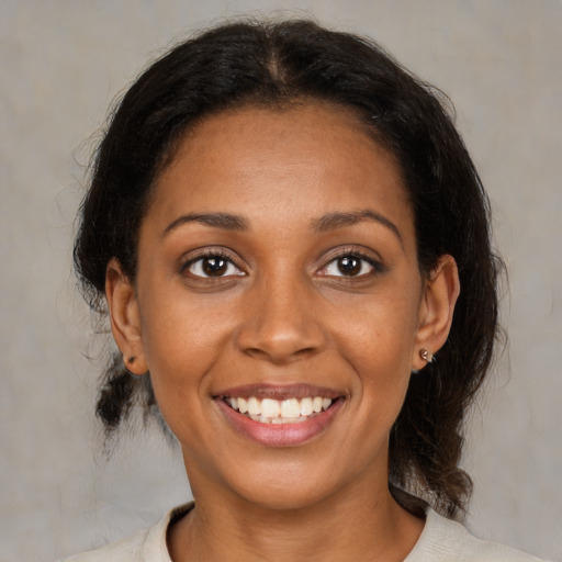 Joyful black young-adult female with medium  brown hair and brown eyes