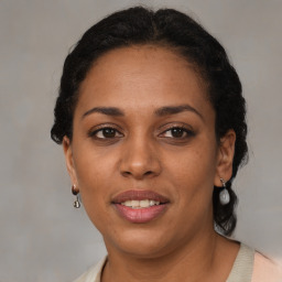 Joyful latino adult female with medium  brown hair and brown eyes