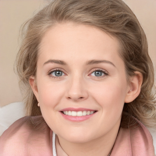 Joyful white young-adult female with medium  brown hair and blue eyes