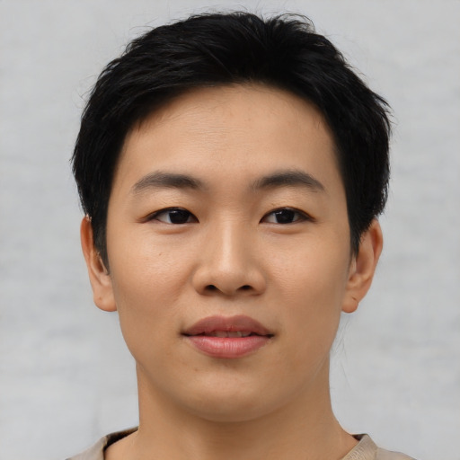 Joyful asian young-adult male with short  black hair and brown eyes