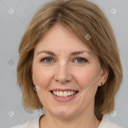 Joyful white adult female with medium  brown hair and grey eyes