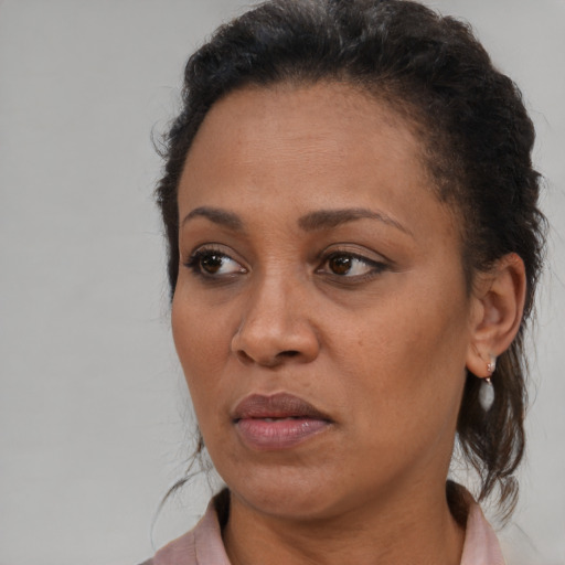 Neutral black adult female with medium  brown hair and brown eyes