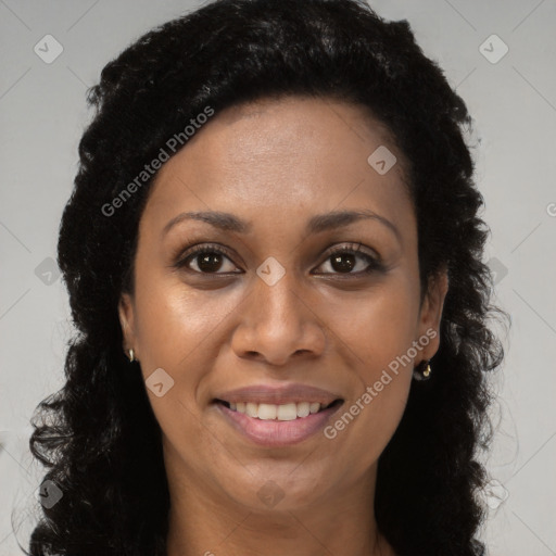 Joyful black young-adult female with long  brown hair and brown eyes