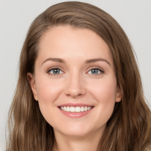 Joyful white young-adult female with long  brown hair and green eyes