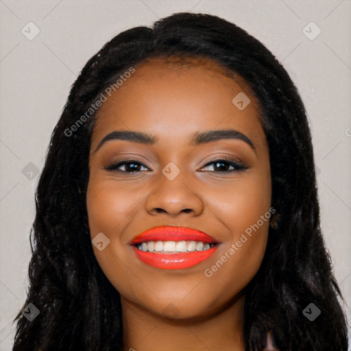 Joyful black young-adult female with long  black hair and brown eyes