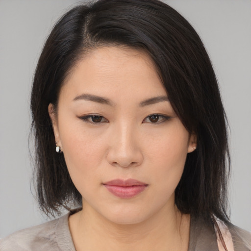 Neutral asian young-adult female with medium  brown hair and brown eyes