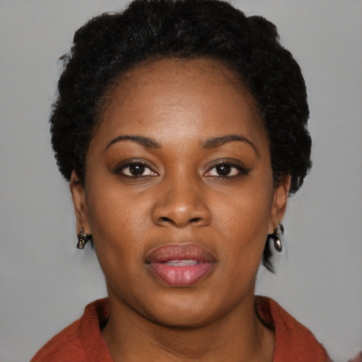 Joyful black young-adult female with medium  black hair and brown eyes