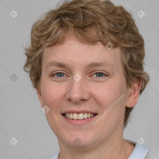 Joyful white young-adult female with short  brown hair and blue eyes