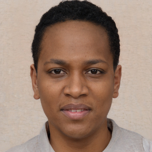 Joyful black young-adult female with short  brown hair and brown eyes