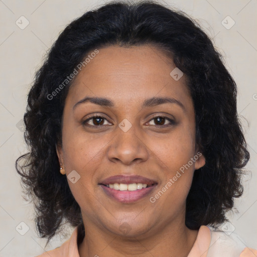 Joyful black adult female with medium  brown hair and brown eyes