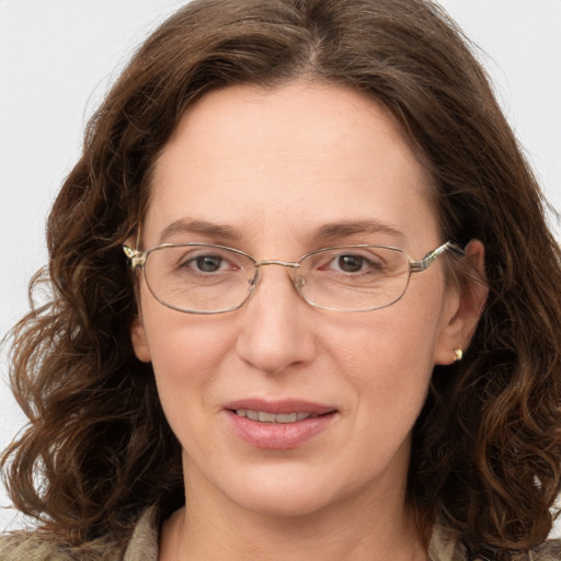 Joyful white adult female with long  brown hair and grey eyes