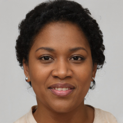 Joyful black adult female with short  brown hair and brown eyes