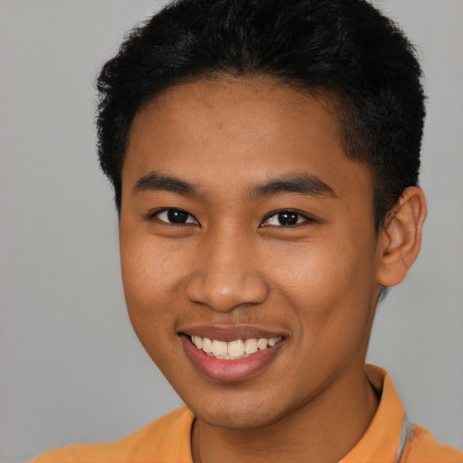 Joyful latino young-adult male with short  brown hair and brown eyes