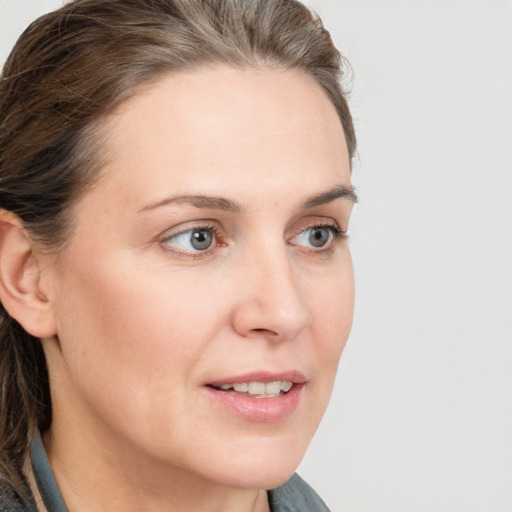 Joyful white young-adult female with medium  brown hair and blue eyes