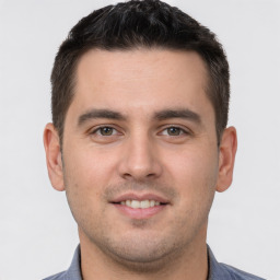 Joyful white young-adult male with short  brown hair and brown eyes