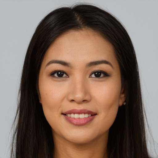 Joyful asian young-adult female with long  brown hair and brown eyes