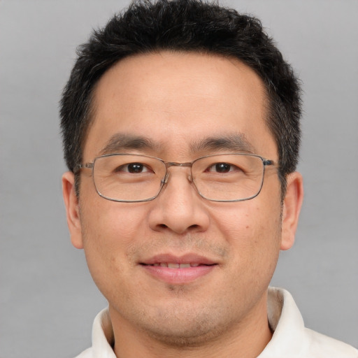 Joyful white adult male with short  brown hair and brown eyes