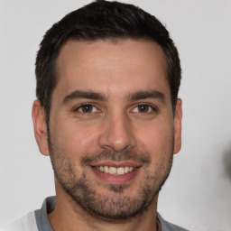 Joyful white young-adult male with short  brown hair and brown eyes