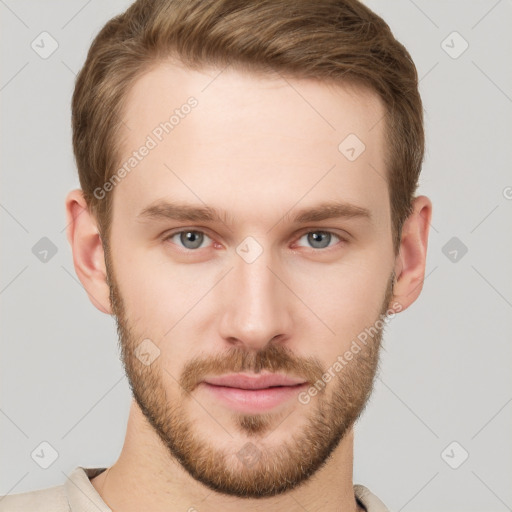 Joyful white young-adult male with short  brown hair and grey eyes