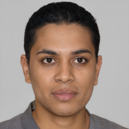 Joyful latino young-adult male with short  black hair and brown eyes