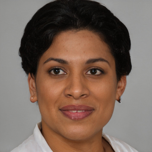 Joyful latino young-adult female with short  brown hair and brown eyes