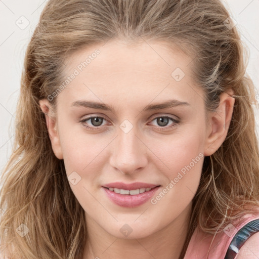 Joyful white young-adult female with long  brown hair and blue eyes