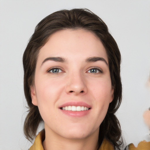 Joyful white young-adult female with medium  brown hair and grey eyes