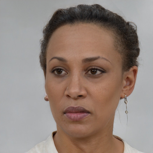 Neutral latino adult female with short  brown hair and brown eyes