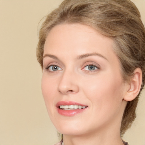 Joyful white young-adult female with long  brown hair and green eyes