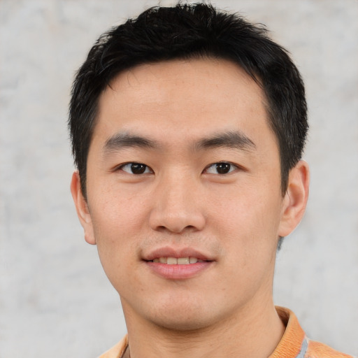 Joyful asian young-adult male with short  brown hair and brown eyes