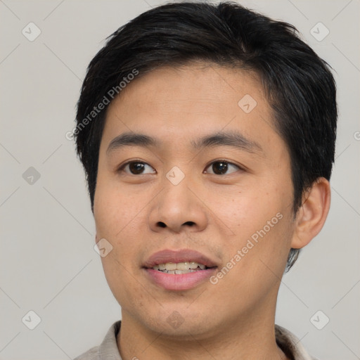 Joyful asian young-adult male with short  brown hair and brown eyes