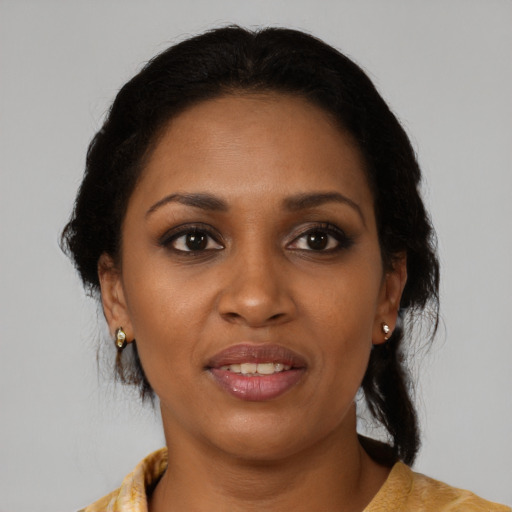 Joyful black adult female with medium  brown hair and brown eyes