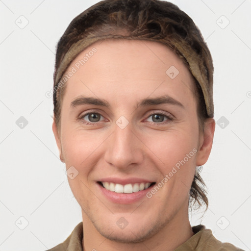 Joyful white young-adult female with short  brown hair and grey eyes